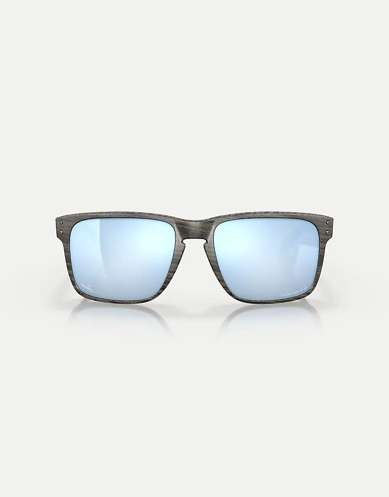 

Солнцезащитные очки Oakley Holbrook xl из коллекции woodgrain с квадратными поляризационными линзами и синим зеркальным покрытием под дерево