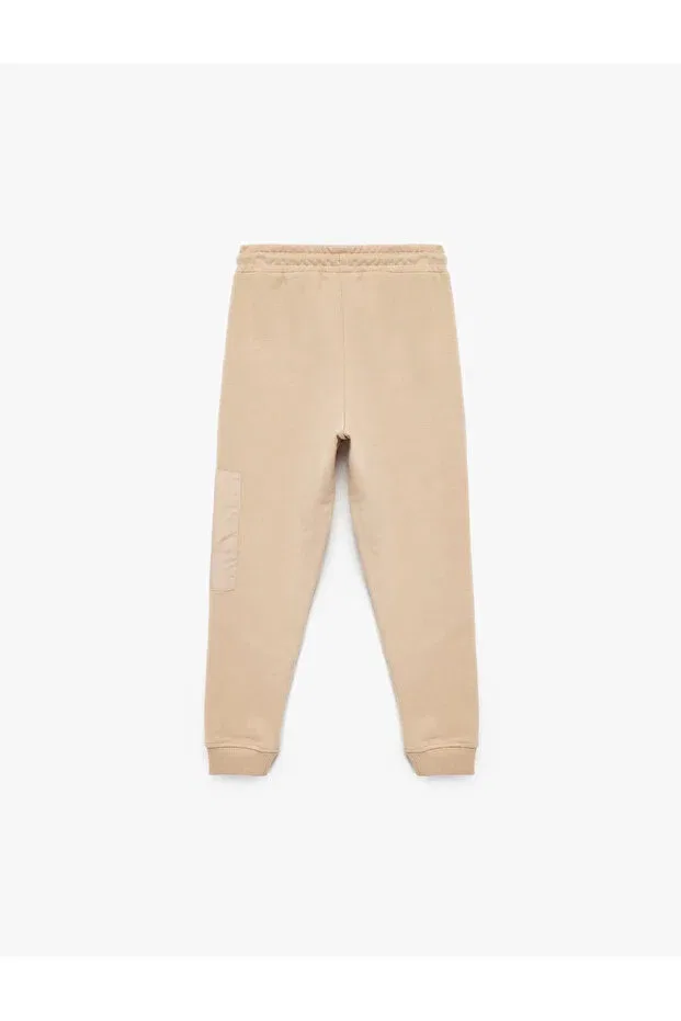 Детские спортивные штаны для мальчиков с принтом Three Thread Raised Print Zipper Pocket Lace-up Waist Jogger Koton, Beige — фото 2