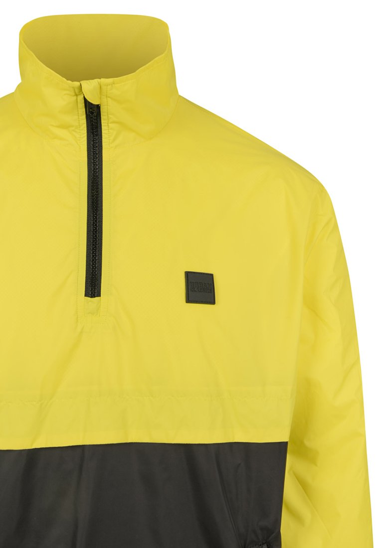 

Легкая куртка STAND UP COLLAR PULL OVER JACKET Urban Classics, желтый