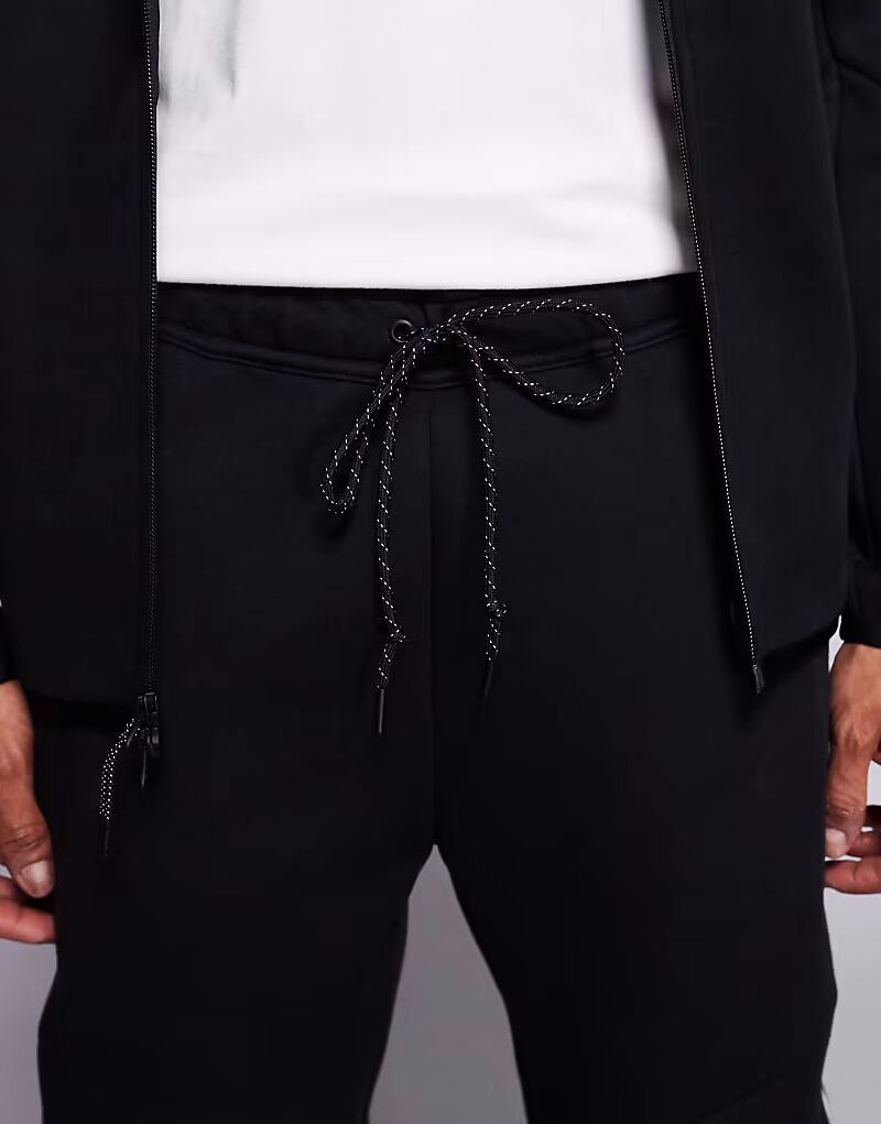 Светоотражающие спортивные брюки Tech Fleece черного цвета Nike — фото 4