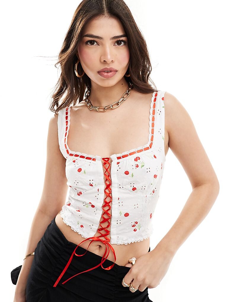 

Корсетная майка ASOS Design – с вышивкой люверсов, контрастной шнуровкой и вишневым принтом