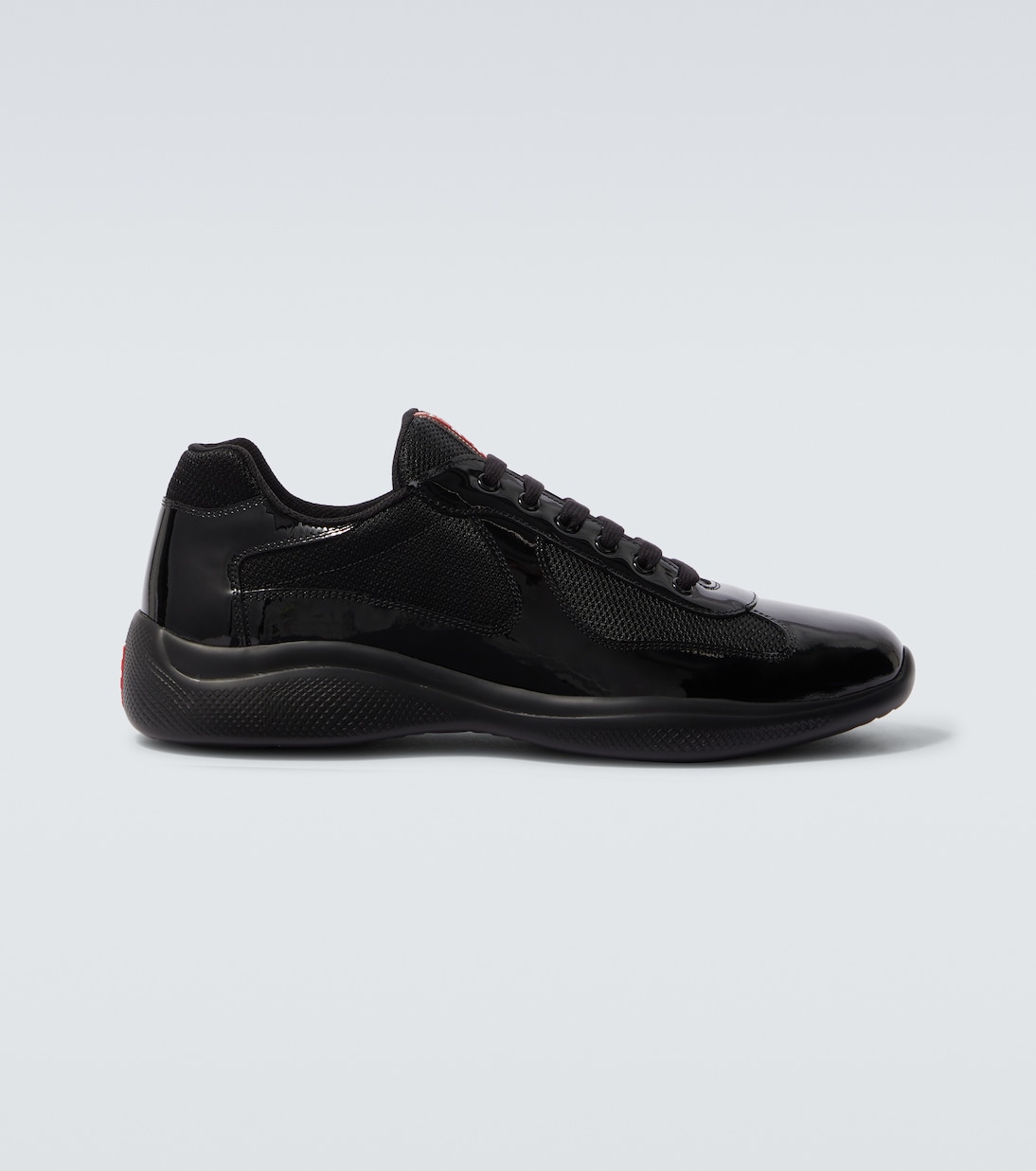 

Кроссовки из лаковой кожи Prada, черный