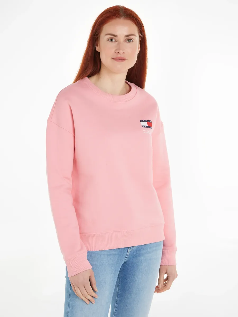 

Толстовка Tommy Jeans "TJW BXY GRAPHIC FLAG CREW" с фирменной этикеткой и флагом-логотипом, розовый