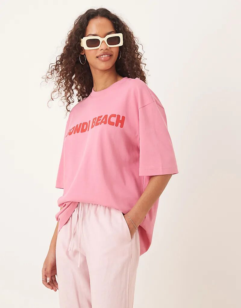 

Футболка Gina Tricot с короткими рукавами и принтом пляжа Bondi Beach, свободного кроя, розового цвета