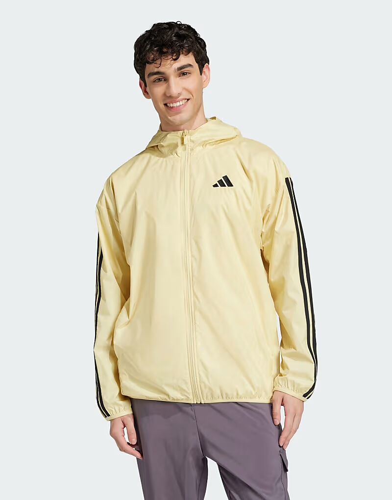 

Ветровка Adidas Essentials с тремя полосками в цвете пудрово-желтый/черный