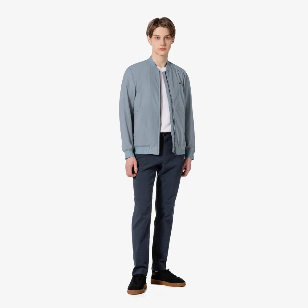 Мужские тёмно-синие брюки чинос из смесовой пряжи от Lacoste