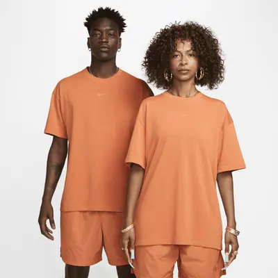 

Футболка Nike NOCTA NOCTA Big Body CS Tee, цвет Hot Curry/Orange Trance/Orange Trance
