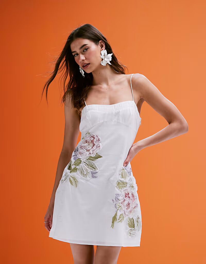 

Платье-мини на бретельках ASOS DESIGN с вышивкой и цветочной отделкой в ​​рюшах белого цвета