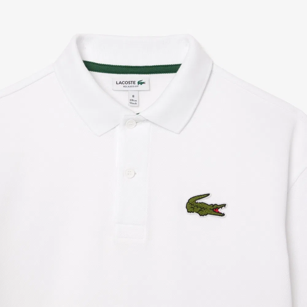 Детская рубашка-поло свободного кроя с коротким рукавом белого цвета от Lacoste — фото 4