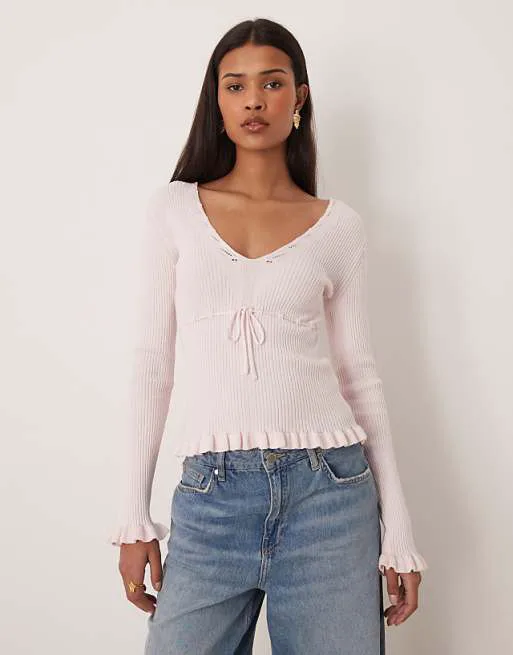 

Розовый вязаный топ с оборками и длинными рукавами Gina Tricot