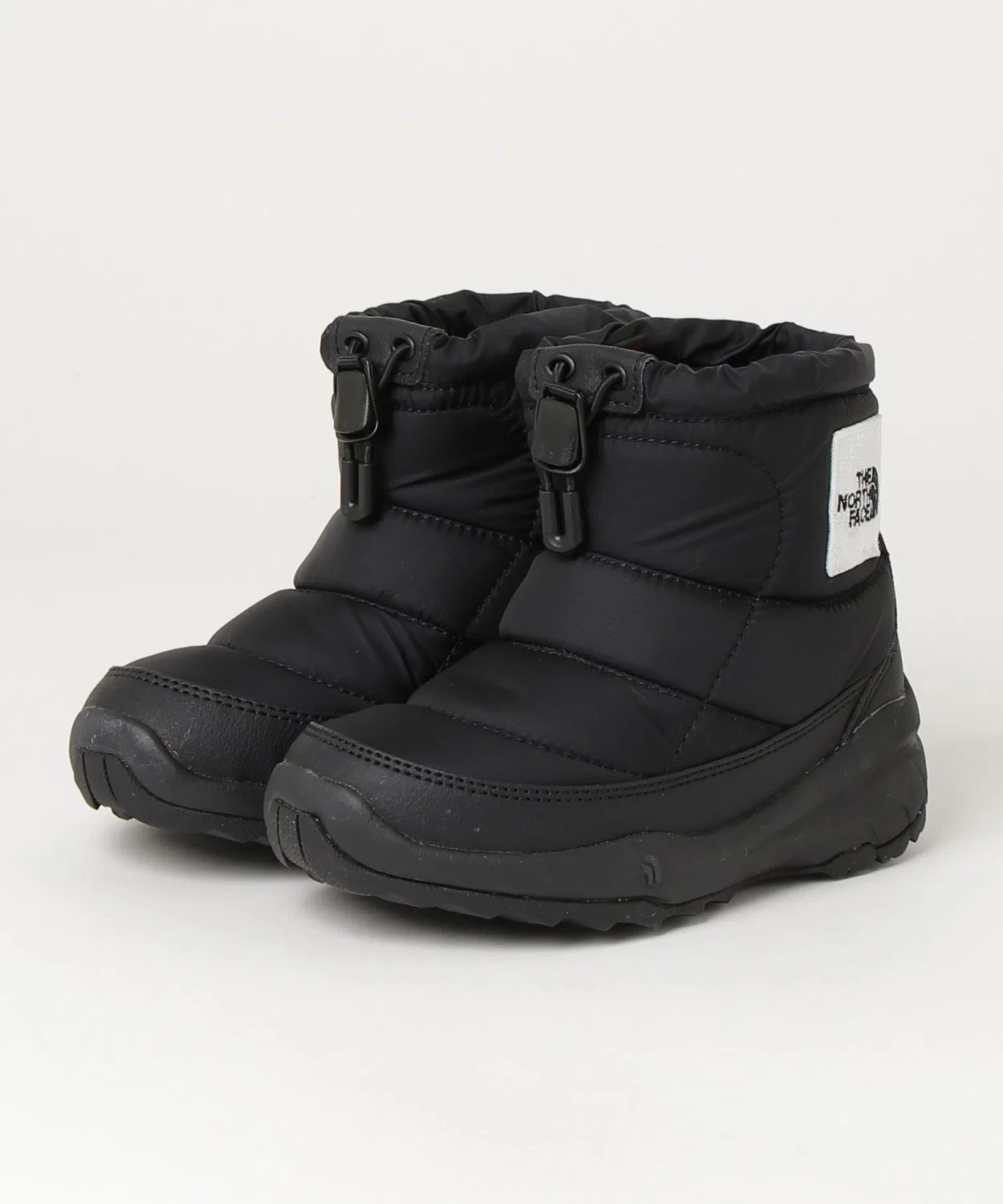 Зимние ботинки The North Face Nuptse Bootie Logo Short детские, чёрно-белые