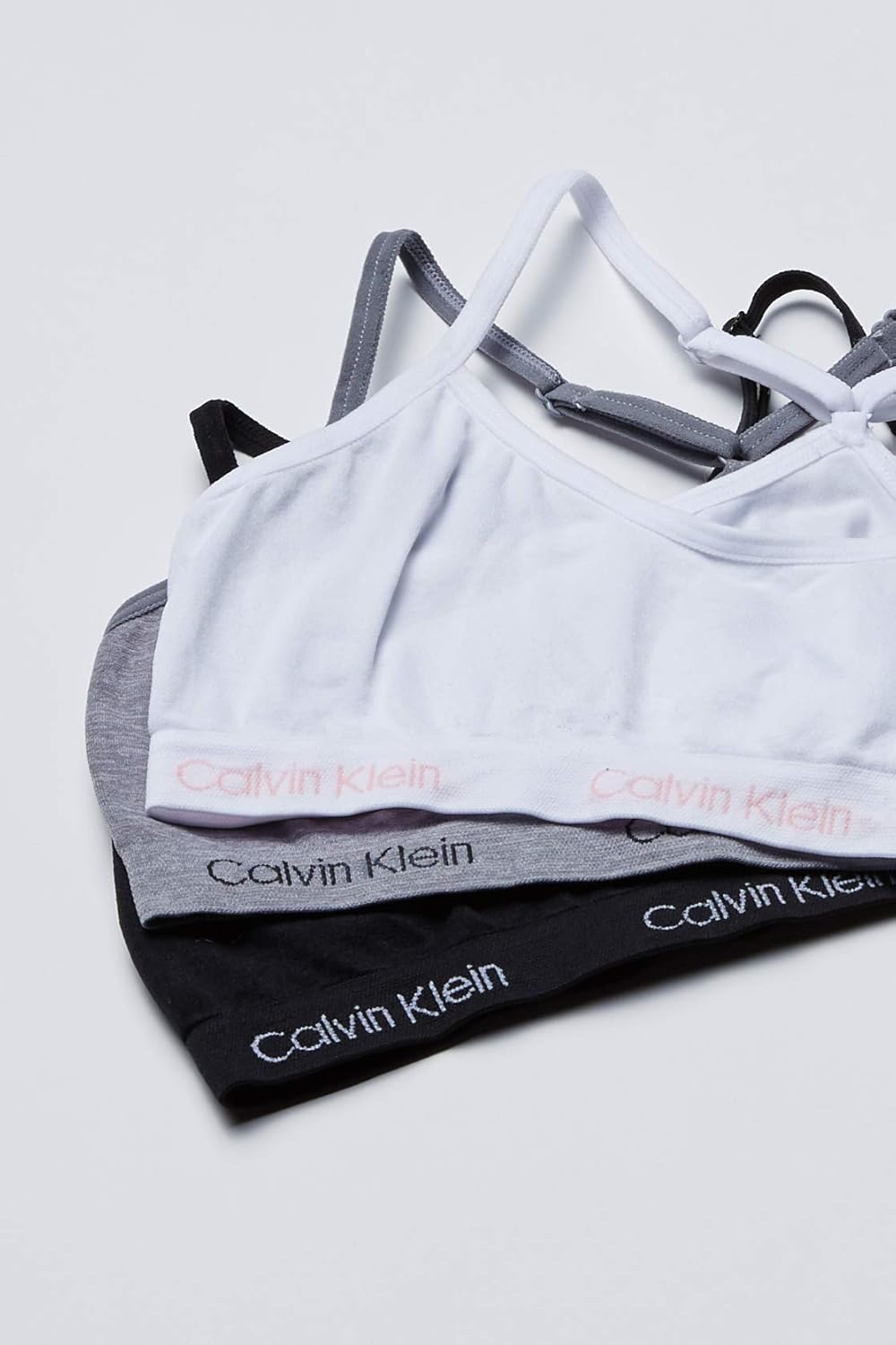 

Бесшовный укороченный бюстгальтер-борцовка Calvin Klein для девочек, мультиупаковка, спортивный бюстгальтер, 3 Pack - Heather Grey, White, Black