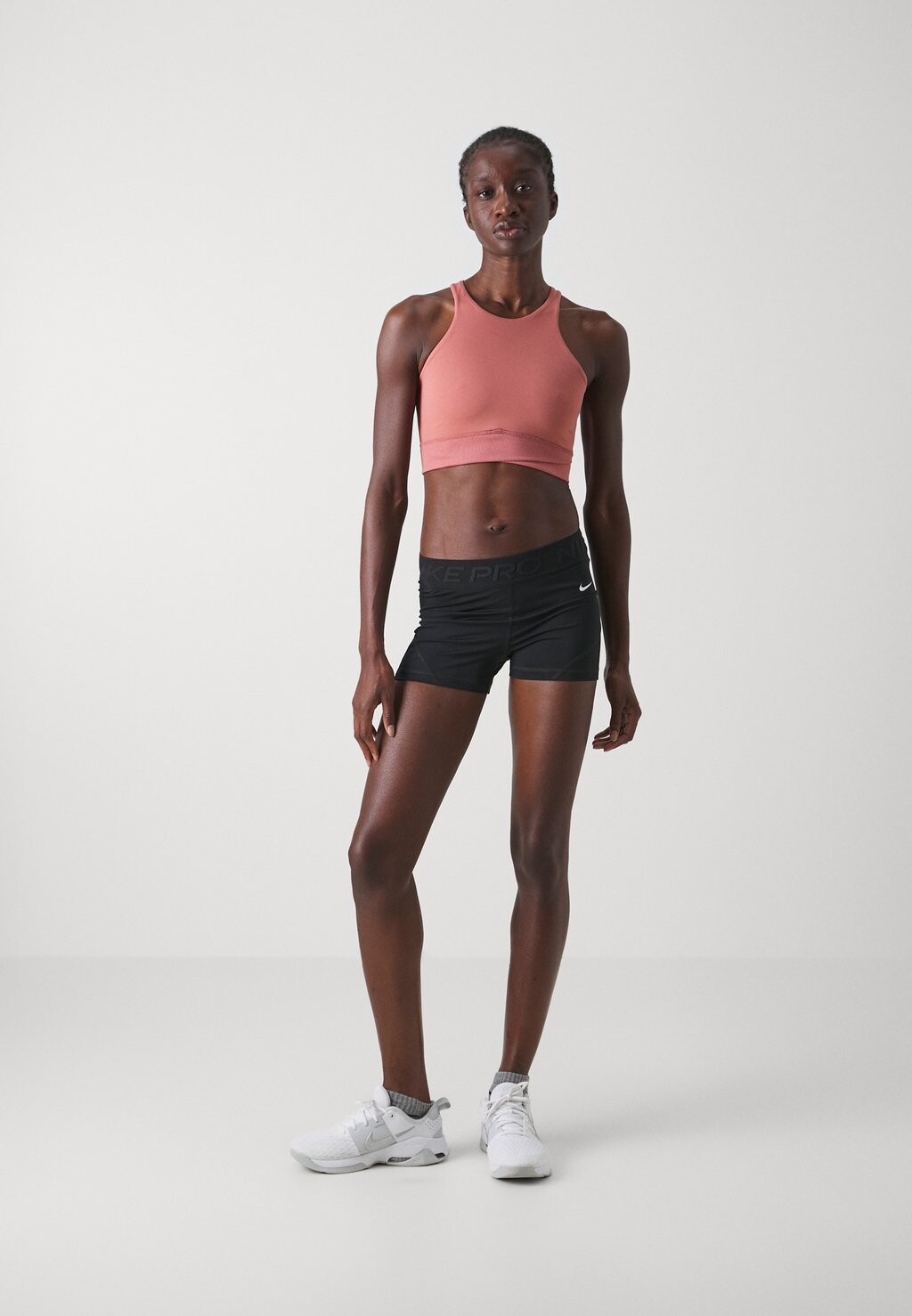

Спортивный бюстгальтер с легкой поддержкой TWIST BRA Nike, розовый