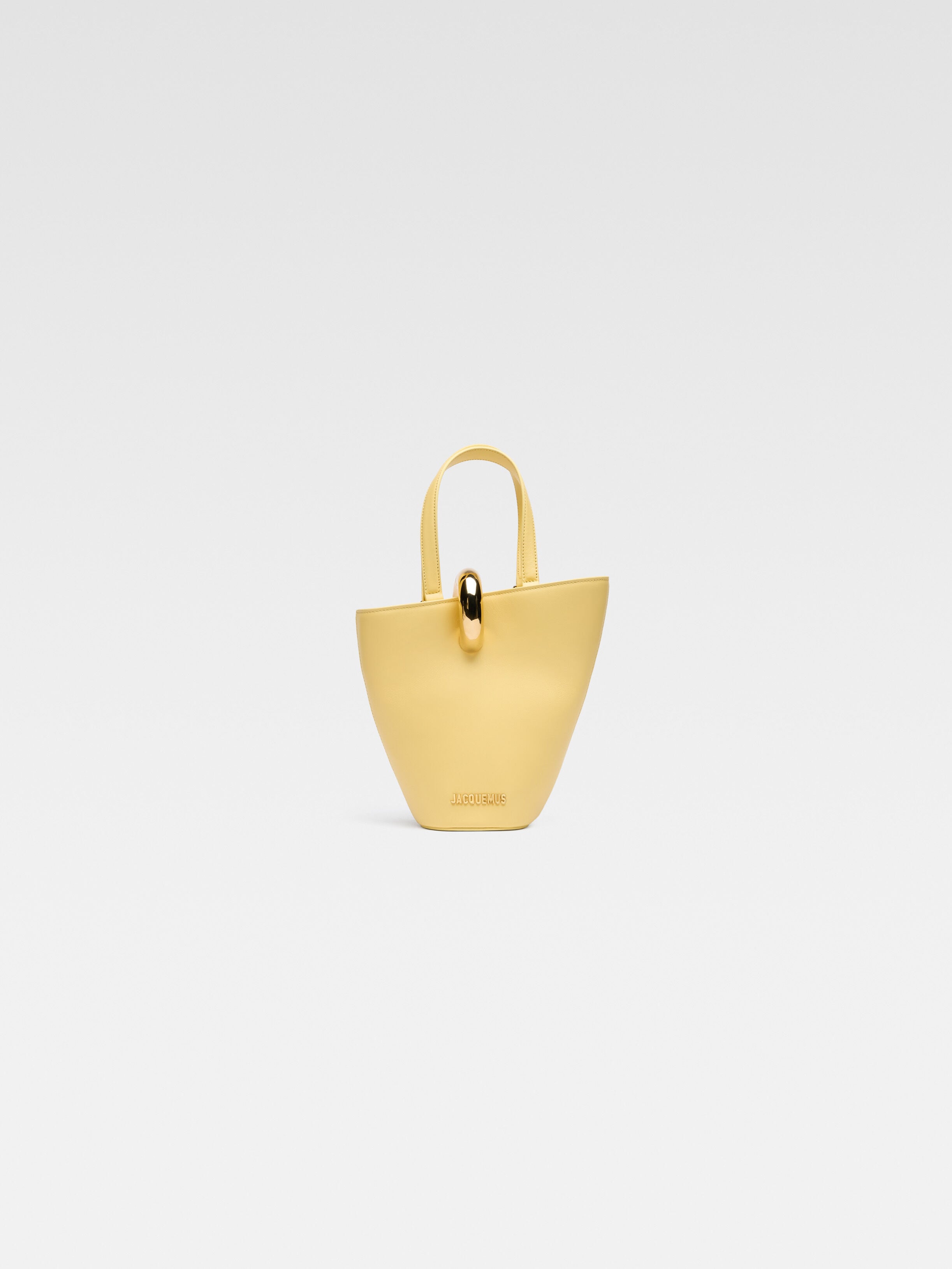 

Асимметричная мини-сумка-ведро JACQUEMUS The small Bambola, светло-желтый