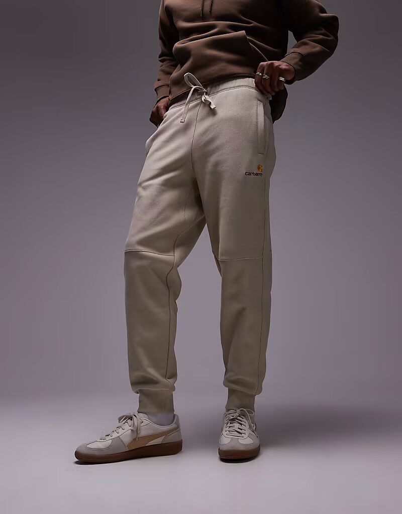 

Спортивные брюки Carhartt WIP American Script бежевого цвета