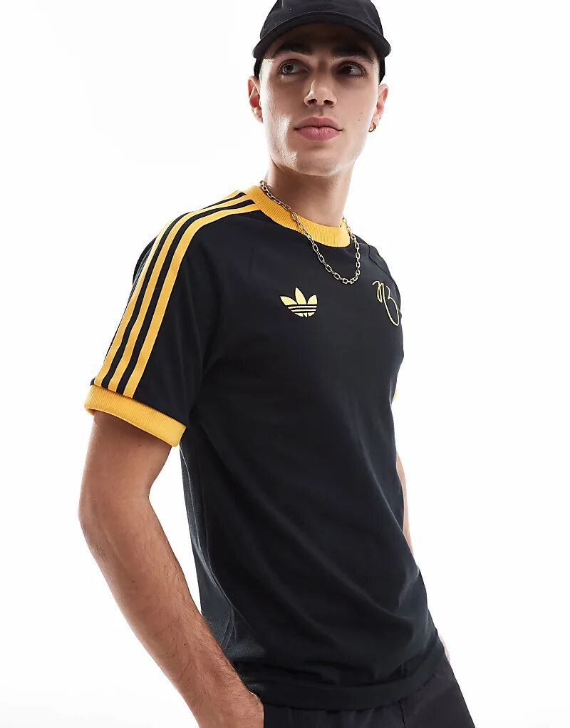 

Футболка Jude Bellingham в черном и золотом цветах adidas Originals