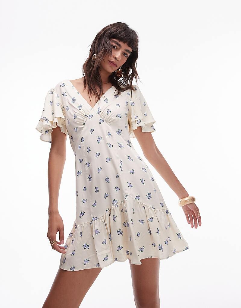 

Topshop – Bella – Завязанное мини-платье с расклешенными рюшами цвета слоновой кости с цветочным узором