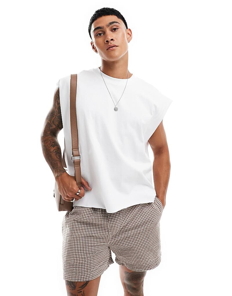 

Белая тяжелая футболка без рукавов ASOS DESIGN с очень объемным кроем и необработанными краями