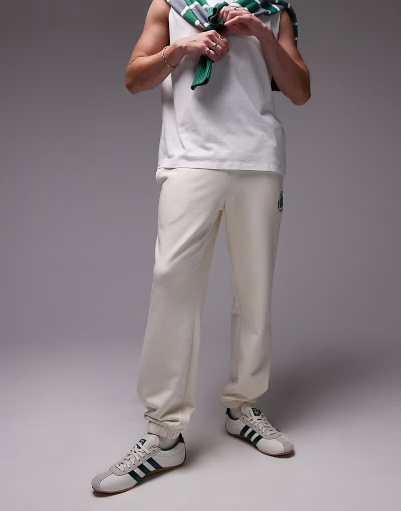 

Lacoste - спортивные брюки белого цвета с теннисной эмблемой