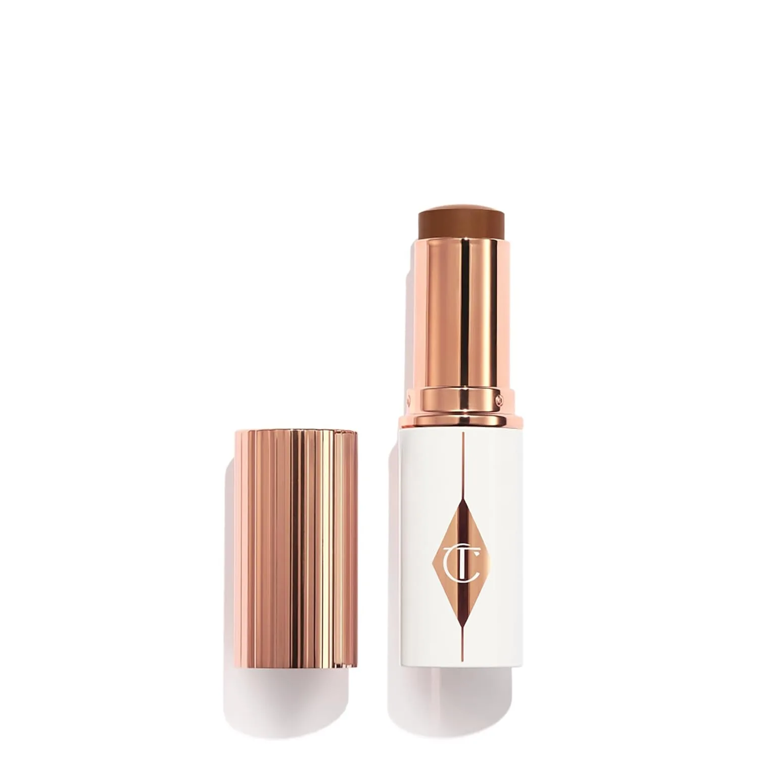 Charlotte Tilbury Unreal Skin Tint & Sheer Glow Hydrating Foundation Stick - тональная основа с увлажняющим эффектом и легким покрытием, 15 Deep - Deep with warm undertones