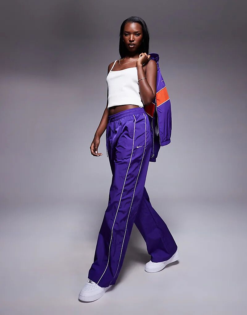 

Тканые спортивные брюки Nike Windrunner фиолетового цвета