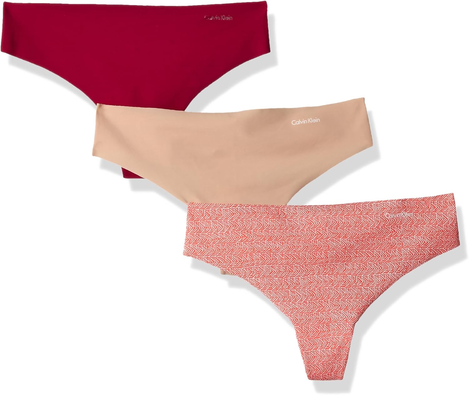 

Женские бесшовные трусики-стринги Calvin Klein Invisibles, 3 шт., Lust/Light Caramel/Linear Ink Geo Impulse