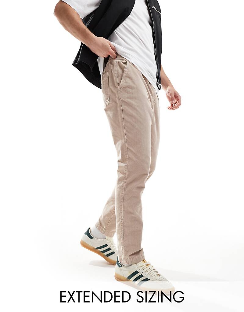 

Серо-коричневые вельветовые брюки зауженного кроя с эластичной резинкой на талии ASOS DESIGN Taupe