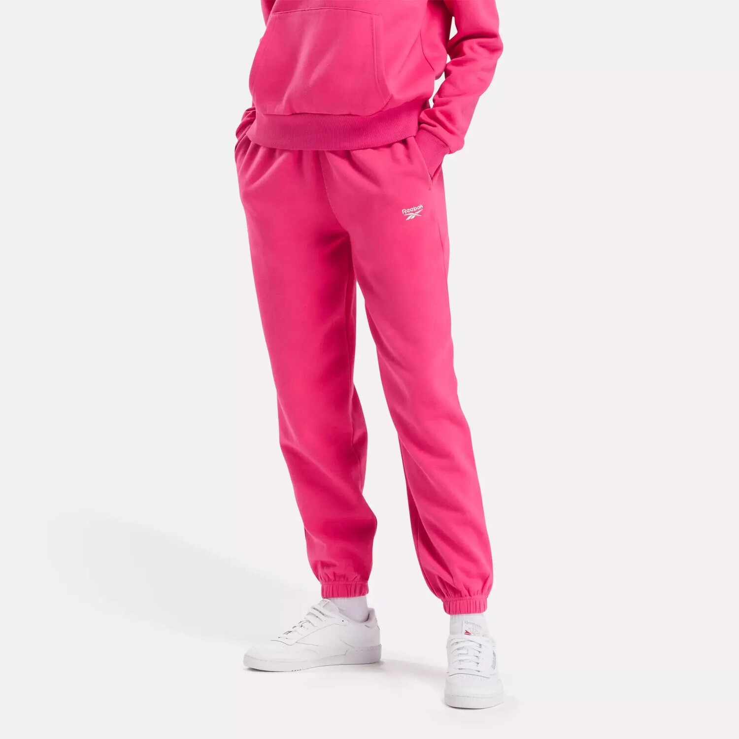 

Флисовые джоггеры с маленьким логотипом Identity Reebok, розовый