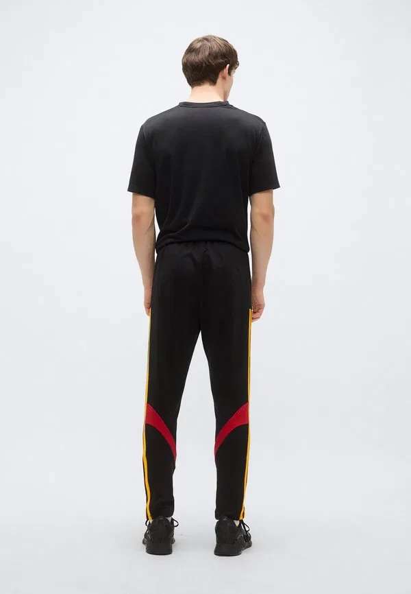 Спортивные штаны house of tiro nations pack, черные/красные/золотистые цвета team power Adidas Sportswear, Black/Team Power Red/Collegiate Gold-Coloured — фото 3