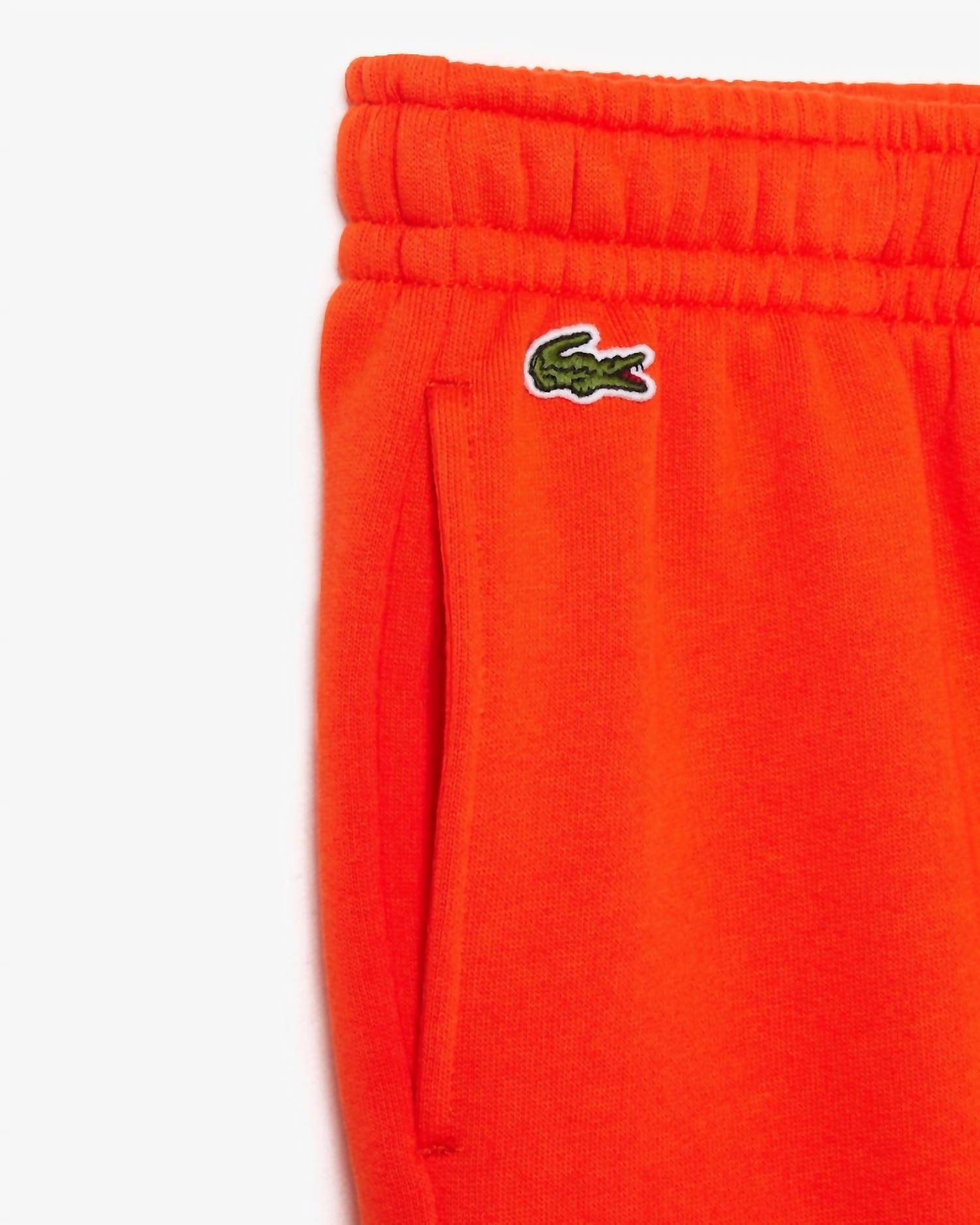 Детские унисекс-спортивные штаны оранжевые Lacoste — фото 2