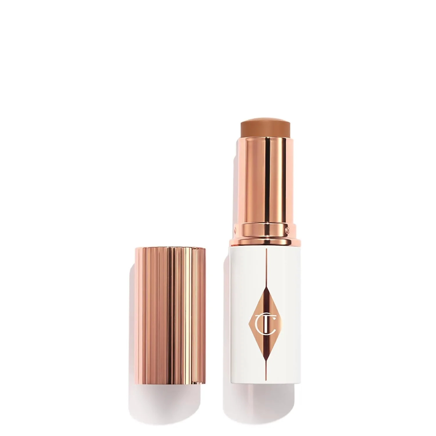 Charlotte Tilbury Unreal Skin Tint & Sheer Glow Hydrating Foundation Stick - кремовая тональная основа с легким покрытием и увлажняющим эффектом, 12.5 Tan - Tan-deep with neutral undertones