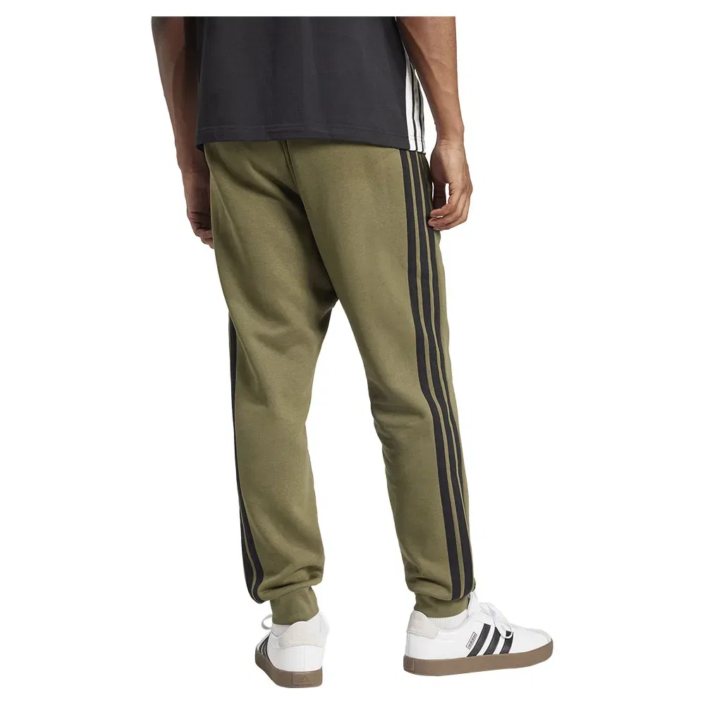 Брюки флисовые с лампасами Adidas Essentials 3 Stripes Fleece joggers, зеленый — фото 2