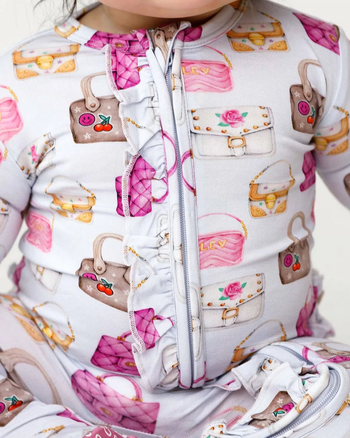 Детский боди-комбинезон с закрытыми ножками и оборками Jules Ruffled Zippered Footies Lev Baby, Pinks Purples And Golds — фото 2
