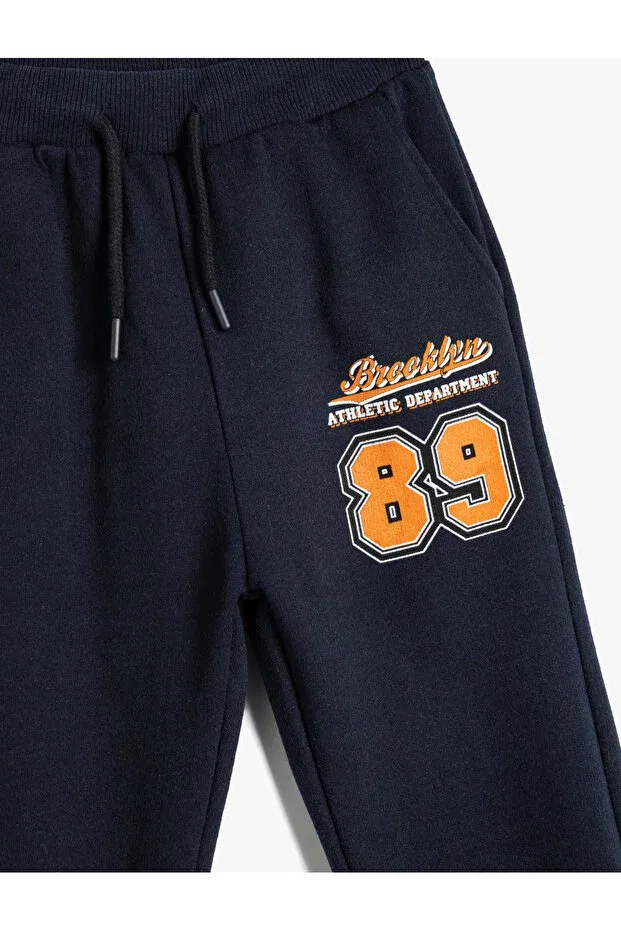 Детские спортивные штаны для мальчиков с принтом Jogger sweatpants with tie waist and sporty print detail Koton, Navy Blue — фото 3