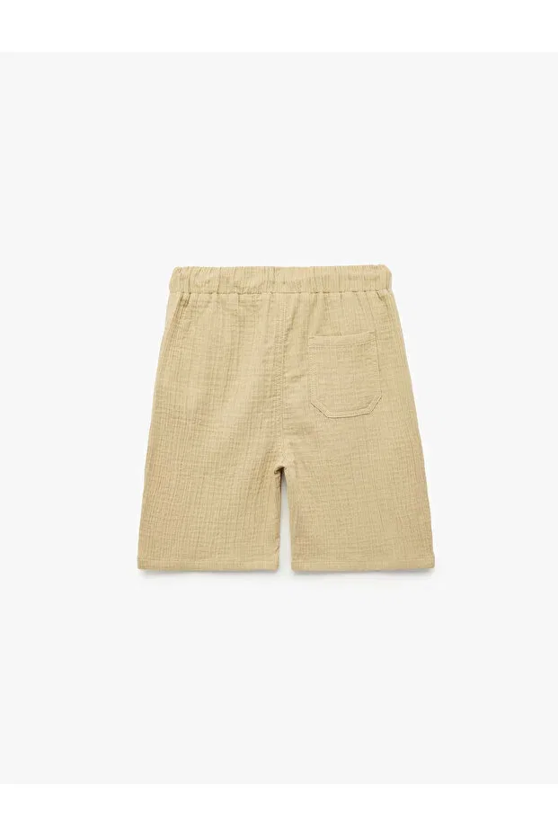 Детские шорты для мальчиков хлопковые Relaxed fit muslin shorts with pockets Koton, Beige — фото 3