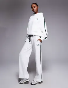 Бело-темно-зеленые джоггеры широкого кроя с полосками по бокам Kaiia