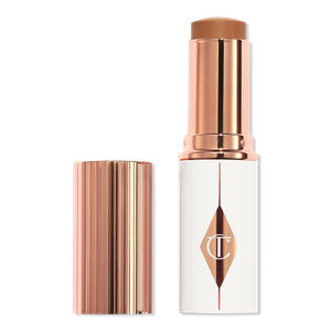 Увлажняющий тональный крем-стик Unreal Skin Sheer Glow Tint Charlotte Tilbury, 12.5 Tan (tan-deep with neutral undertones)