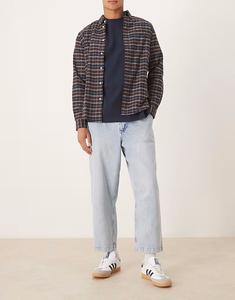 Свободные зауженные джинсы со складками из выбеленного денима Asos Design