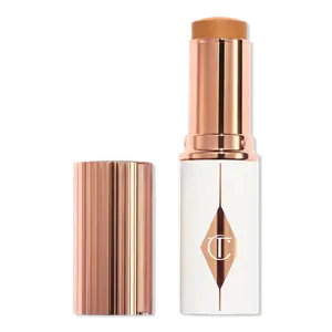 Увлажняющий тональный крем-стик Unreal Skin Sheer Glow Tint Charlotte Tilbury, 12 Tan (tan-deep with warm undertones)