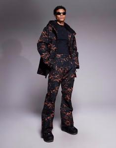 Потертые лыжные брюки с черным и оранжевым принтом Threadbare