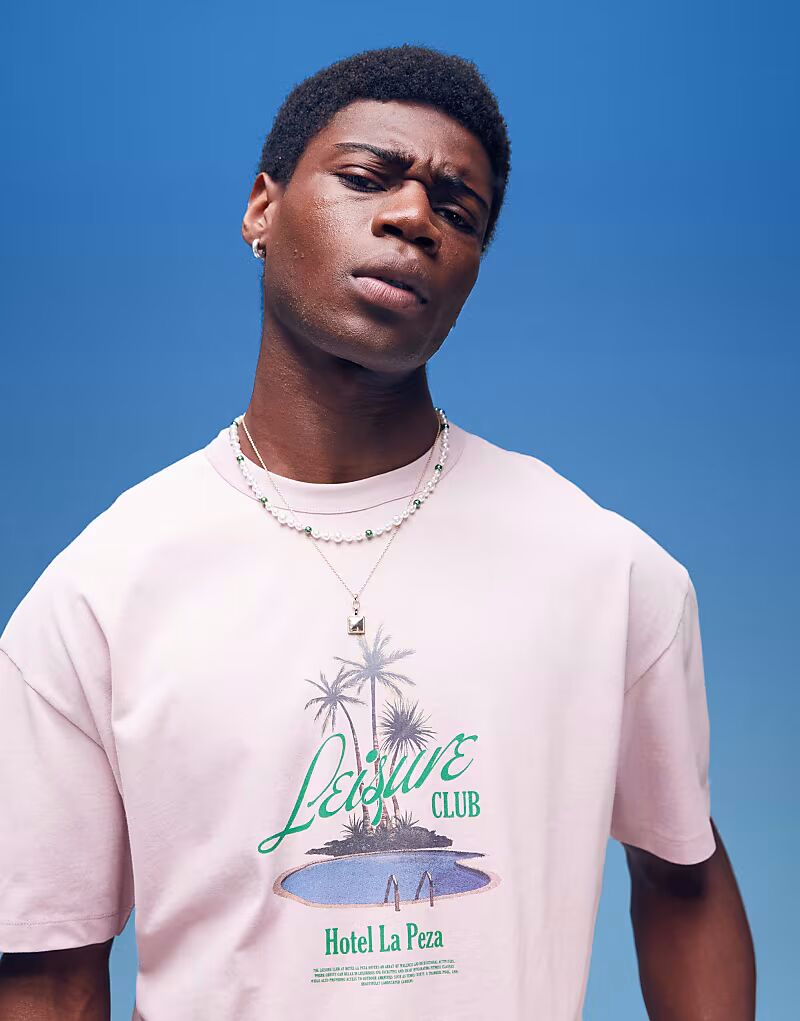 

Футболка свободного кроя ASOS DESIGN из плотной ткани плотностью 220 г/м² с принтом пальмы на груди в выцветшем розовом цвете