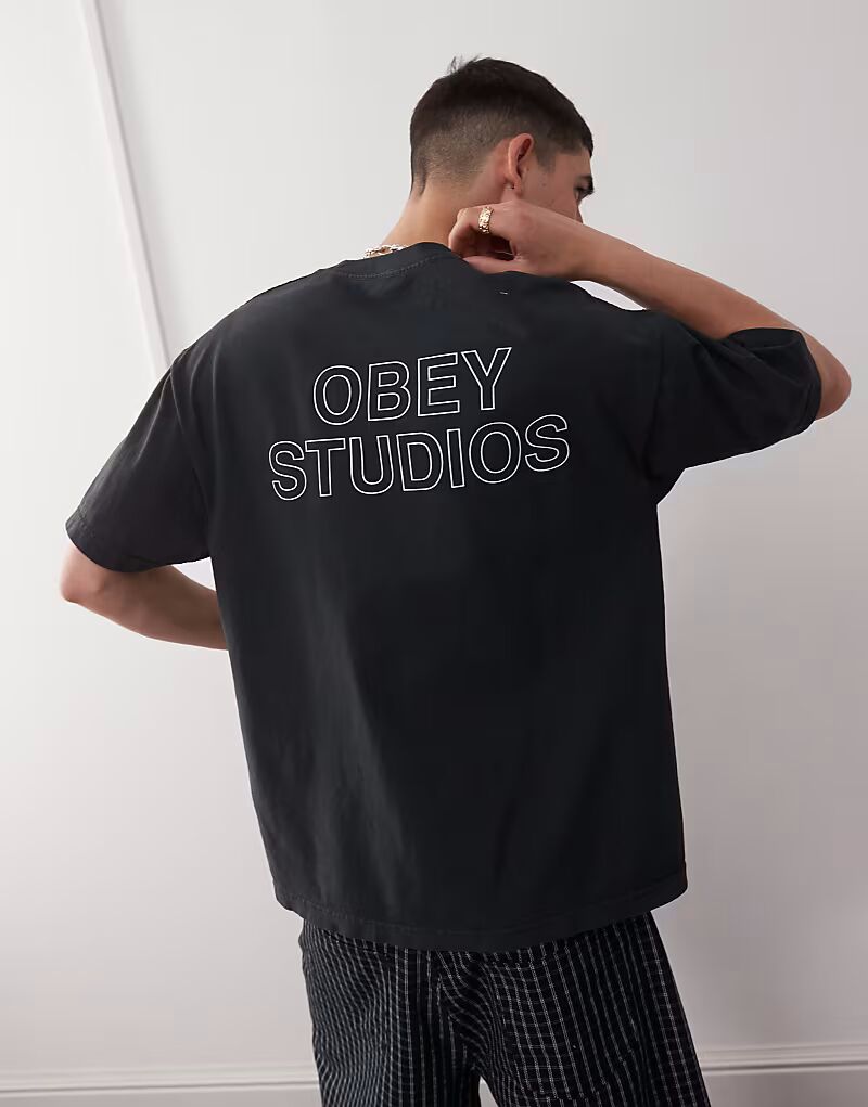 

Obey - футболка пигментированного винтажного черного цвета с логотипом «Studios» и принтом на спине