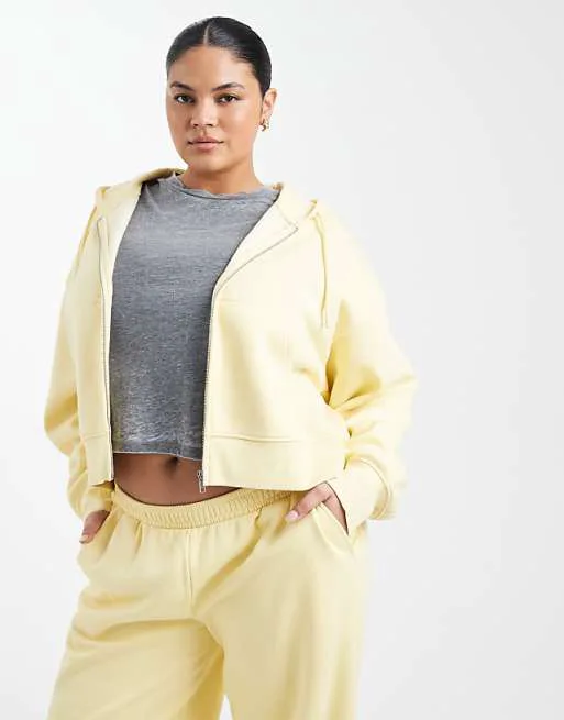 

Желтое укороченное худи на молнии с кисточкой ASOS DESIGN Curve