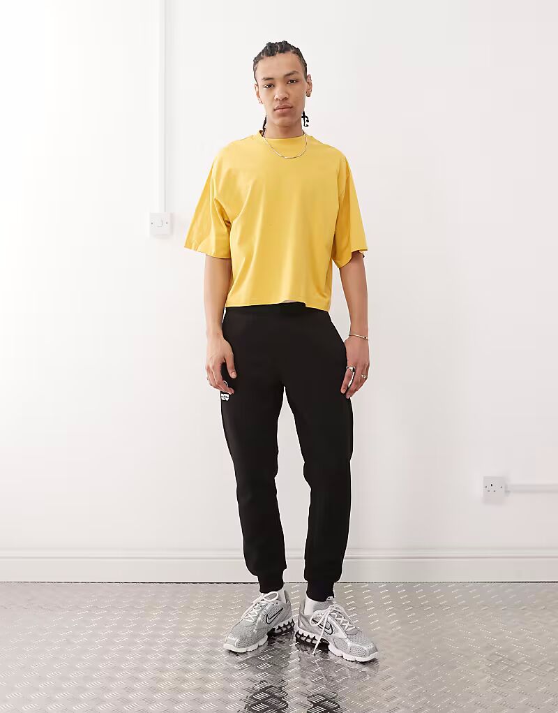 

Черные спортивные брюки с манжетами и логотипом сбоку от Aape By A Bathing Ape
