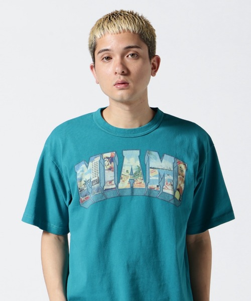 

Открытка с изображением футболки округа Бикини, бренд AVIREX, бирюзовый цвет