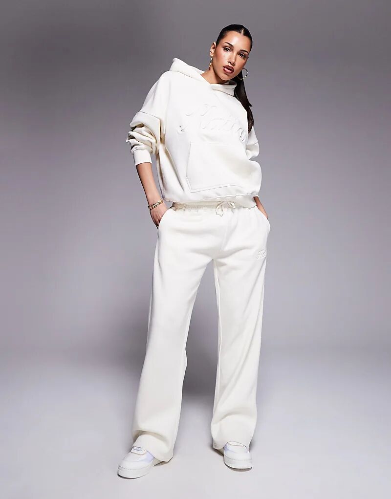 

Спортивные брюки Kaiia из хлопка с тисненым логотипом в цвете «сливочный крем»