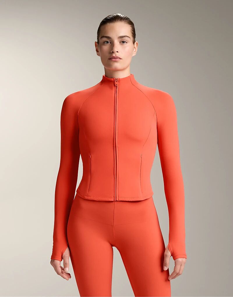 

Легкая теплая куртка OYSHO оранжевого цвета