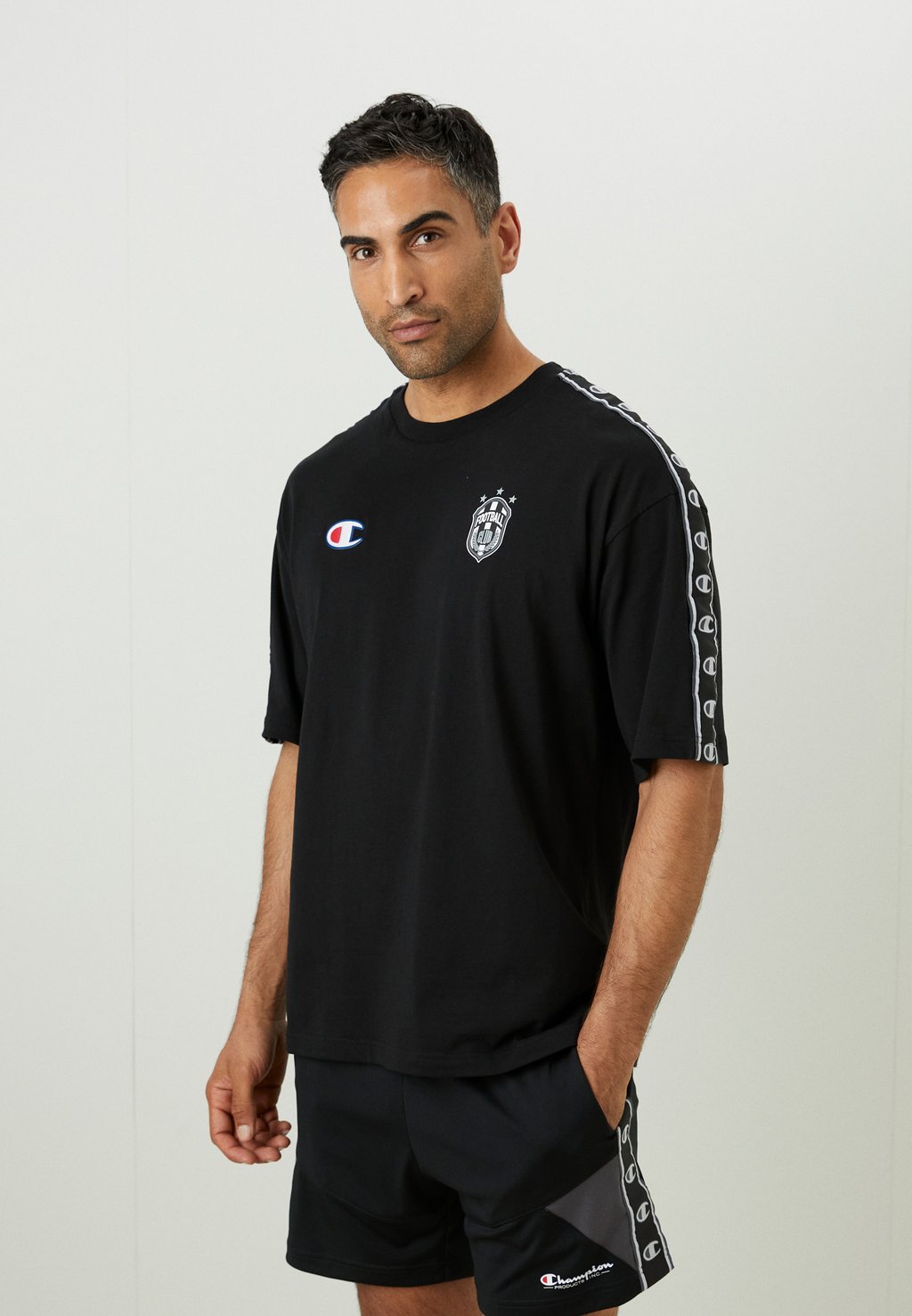 

Футболка с принтом SPORTS HERITAGE - Club wear Champion, черный