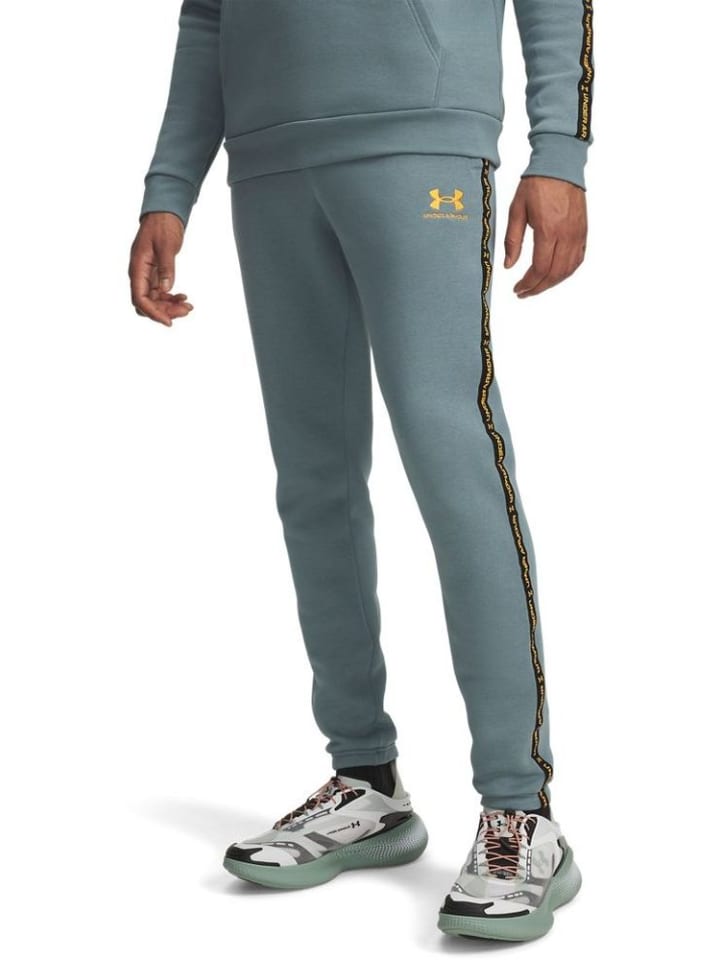 

Спортивные штаны Icon Fleece Taping Jogger синего цвета Under Armour