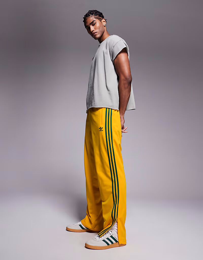 

Спортивные брюки Adidas Originals Firebird желтого цвета